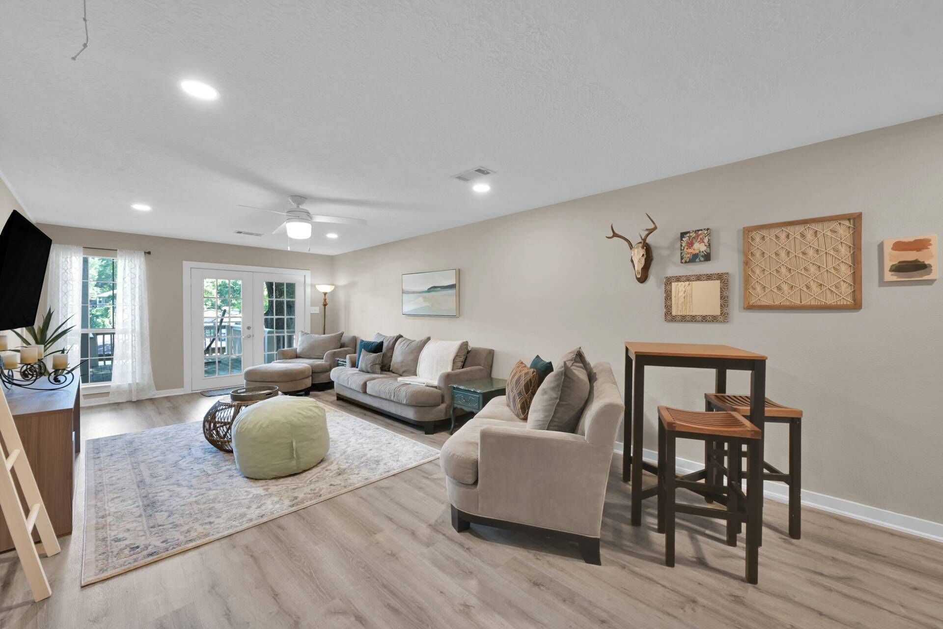A spacious living room with a large sofa, a coffee table, and a dining area with a table and chairs.