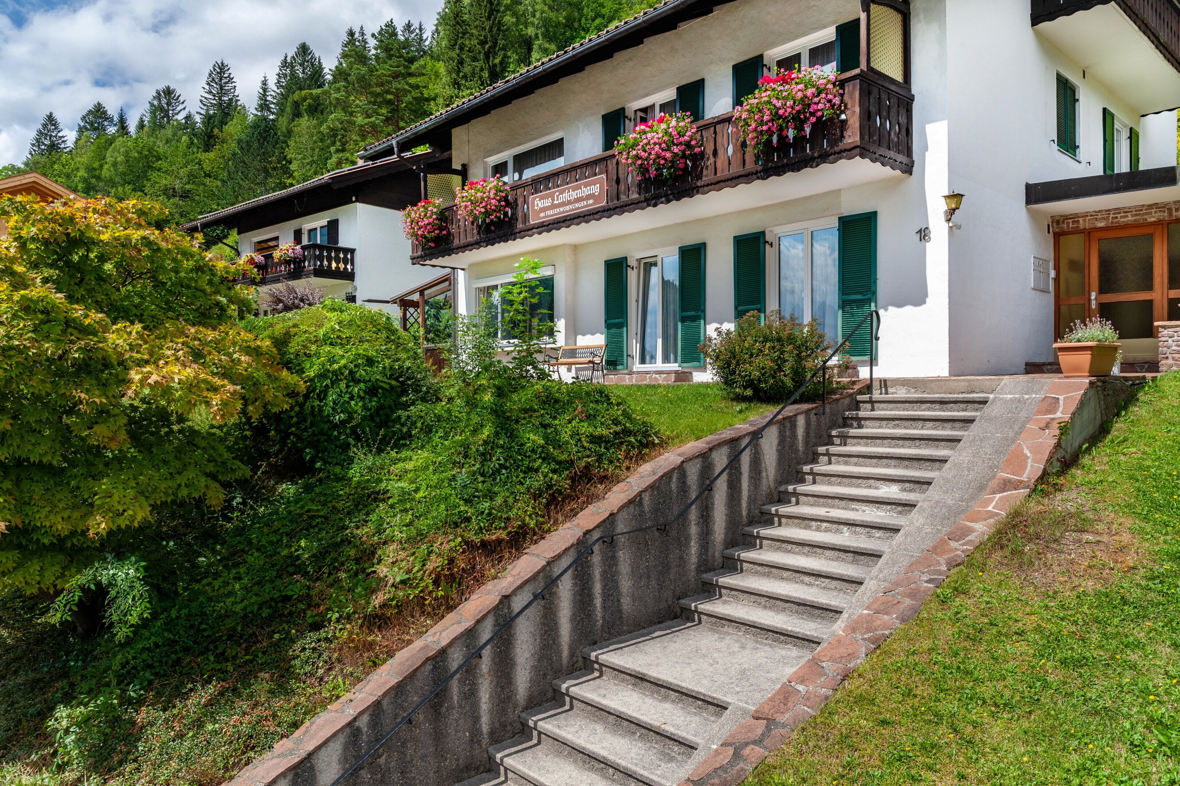 Ein zweigeschossiges Gebäude mit Balkon, Treppe und einem Schild, auf dem 'Haus Endenbach' steht.