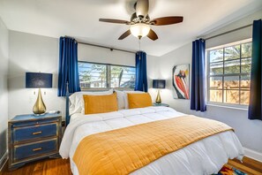 A bedroom with a bed, nightstands, a ceiling fan, and a window with curtains. - Port Charlotte Vacation Rental w/ Heated Pool! (Port Charlotte)