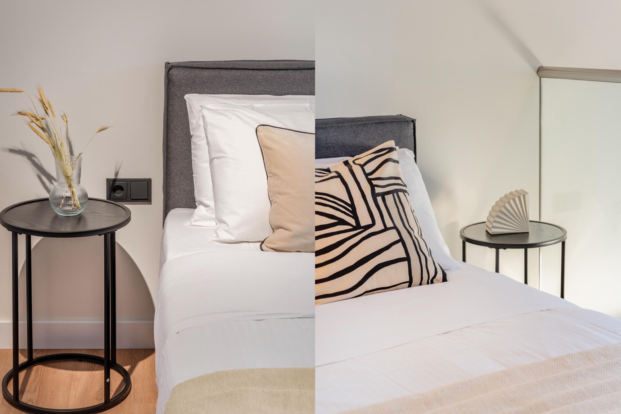 A bedroom with a bed, two pillows, a bedside table, a vase with dried plants, and a decorative object on the table.