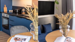 A modern kitchen with a dining area. - Exceptional Living Loft 704 (Athina)