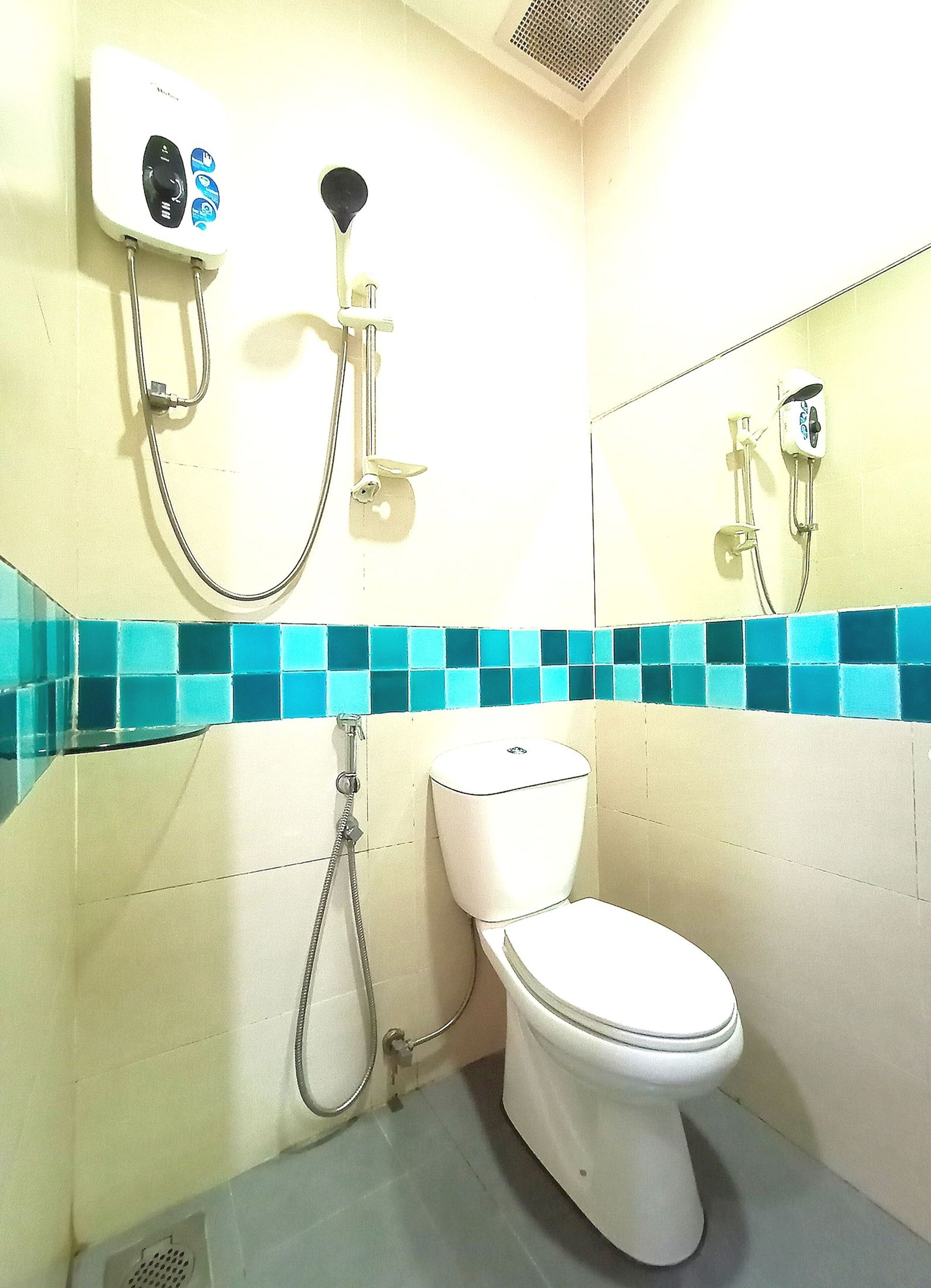 Un baño con inodoro, ducha e inodoro de lavado.