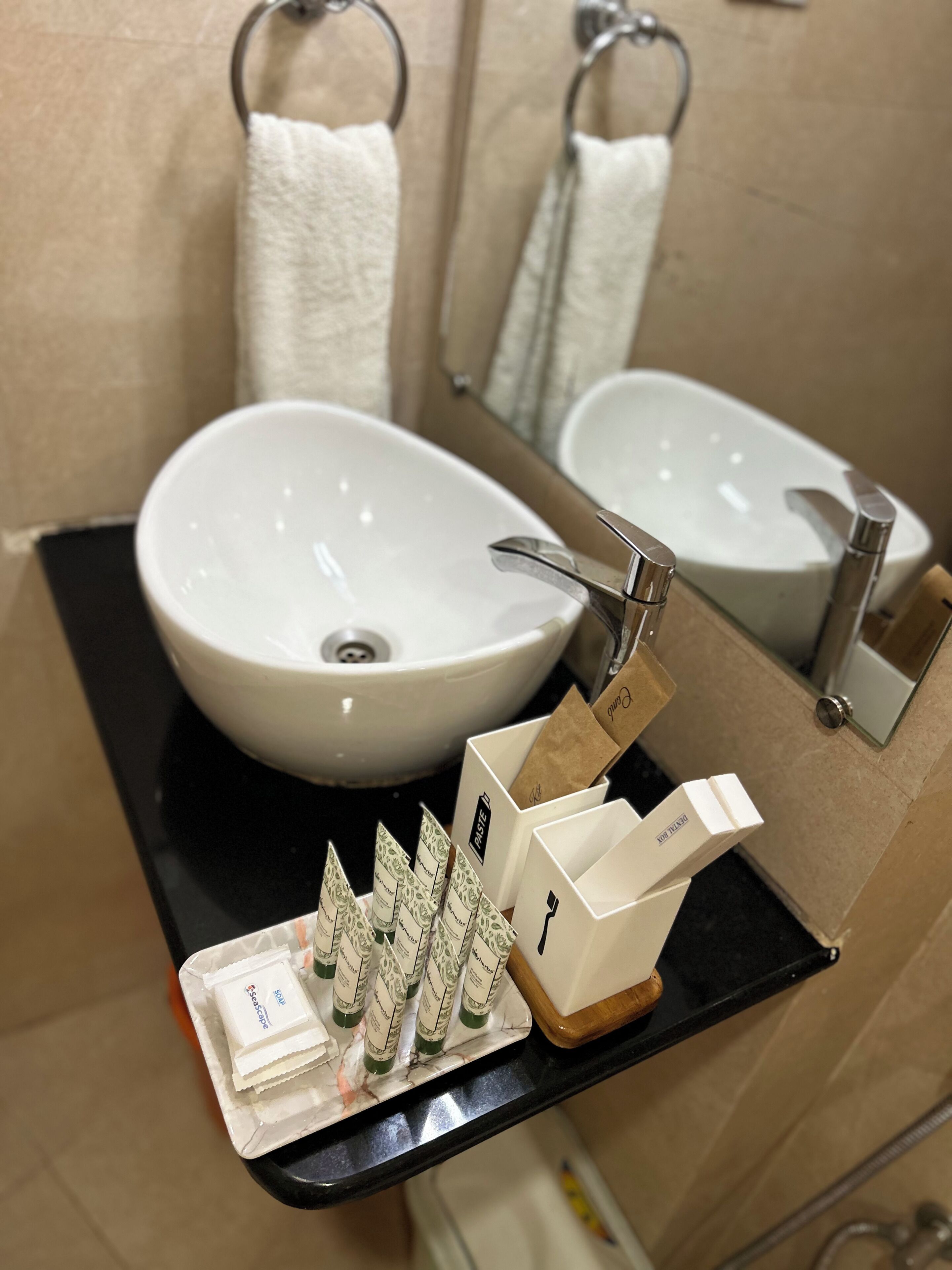 A bathroom with a white sink, a mirror, and a shelf with toiletries.