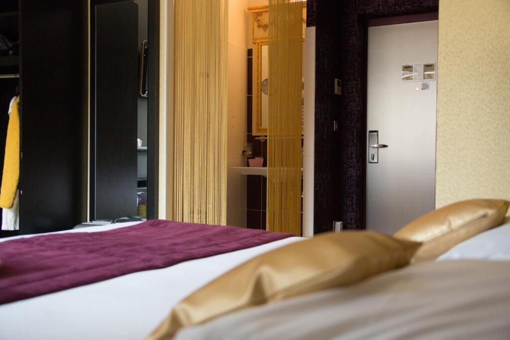 Une chambre d’hôtel avec un lit, une armoire et une porte.