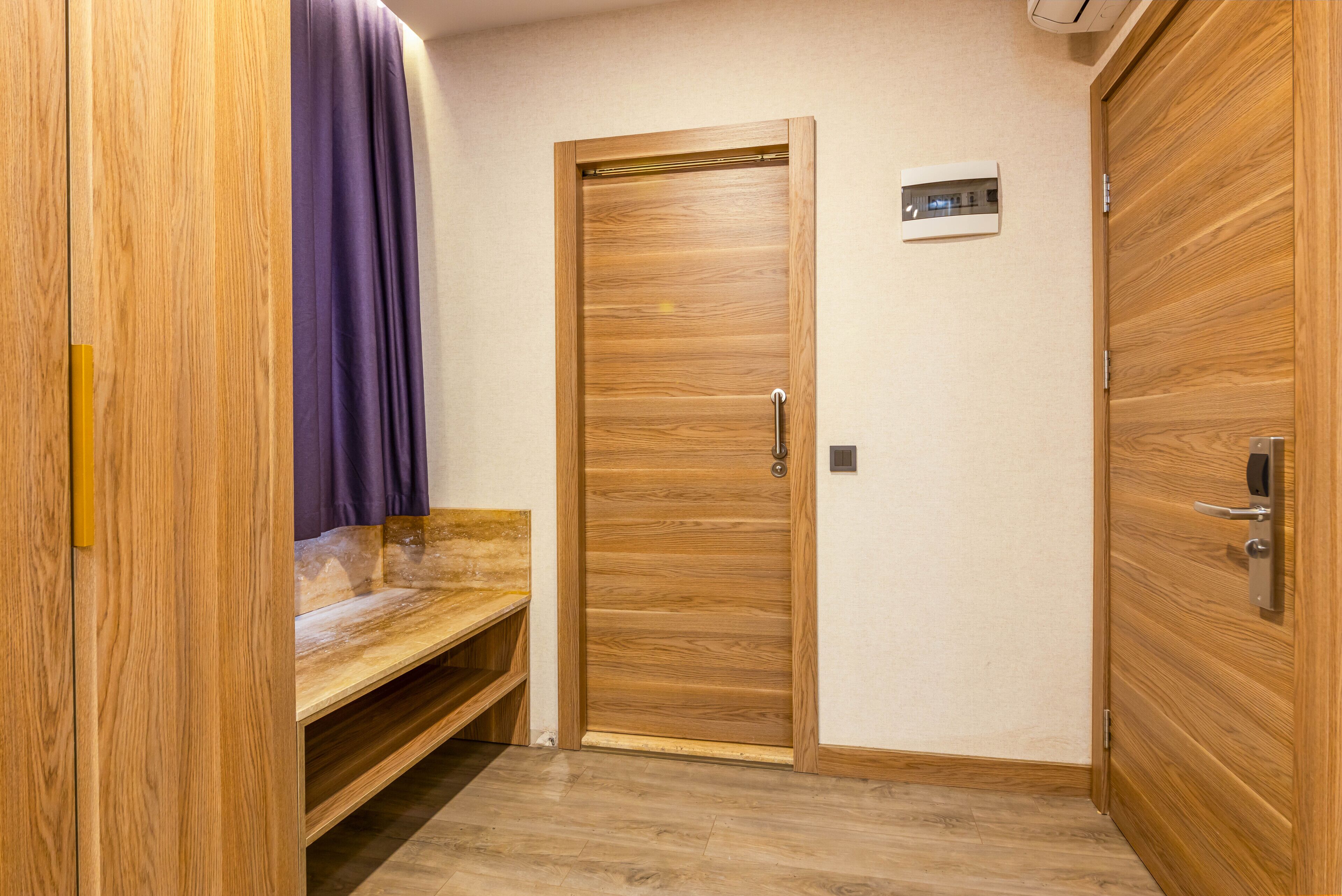 A wooden door with a handle, a bench, and a small shelf.