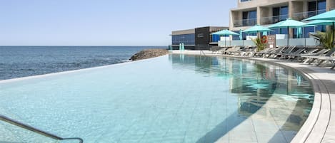 Outdoor pool, pool umbrellas, sun loungers