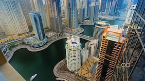 A high-rise urban area with modern skyscrapers, a marina, and a curved road. - Luxe High Floor In Address Marina.36 (Dubai)