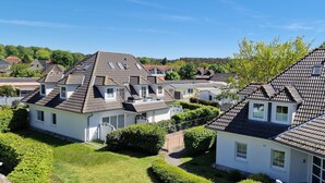 A residential area with houses featuring steeply pitched roofs and dormer windows.