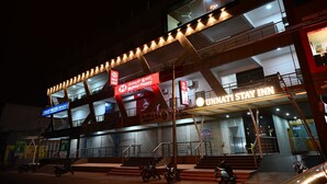 A multi-story building with signage for 'Muthoot Finance' and 'Unnati Stay Inn'. - Unnati Stays Inn, VIJAYAPUR (VIJAYAPUR)