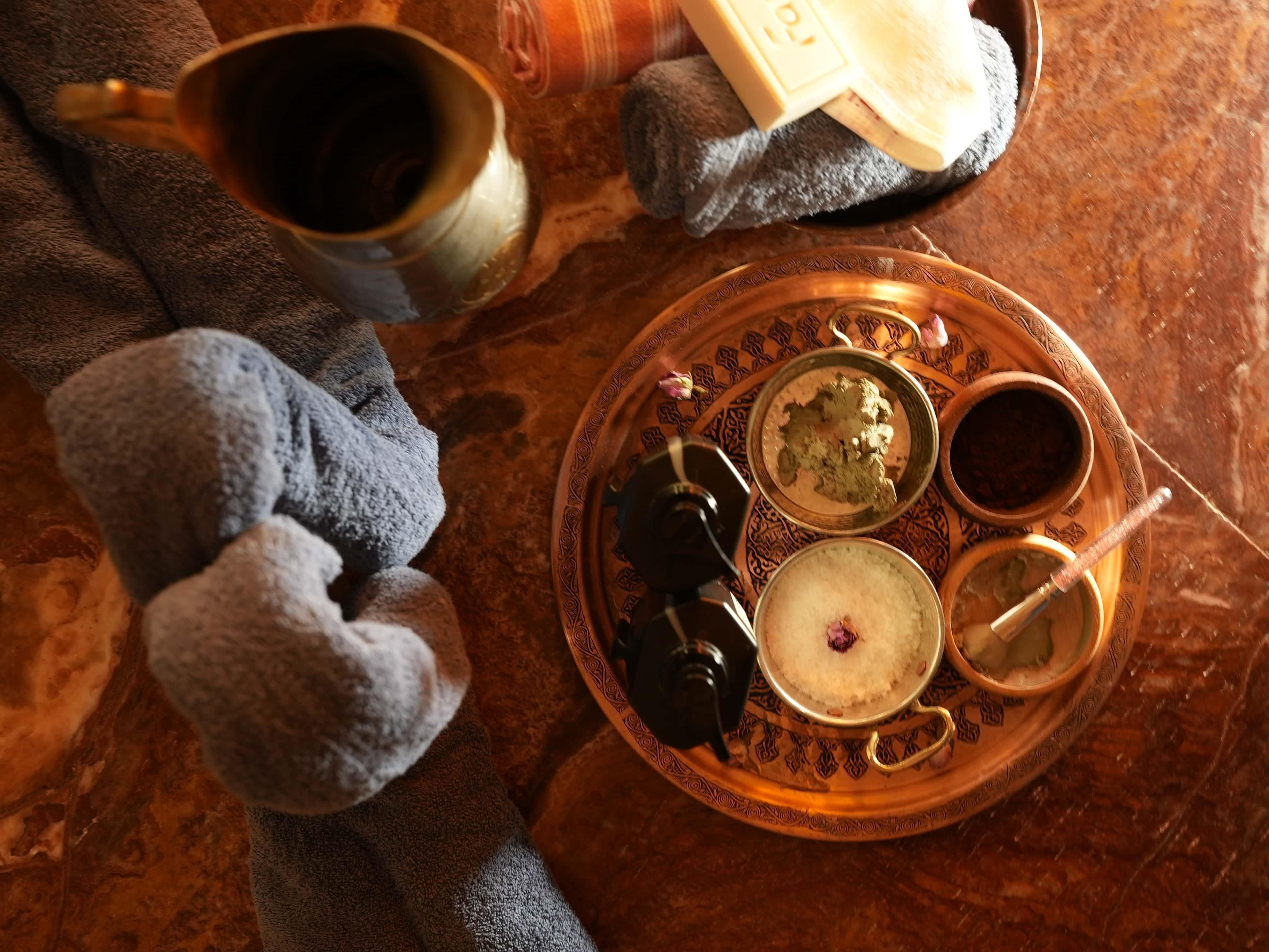 A tray with various food items and a cup, placed on a textured surface.