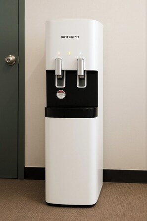 A water dispenser with two spouts, a control panel, and a brand name. - STAY MIDO (Busan)