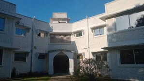 A multi-story building with a central entrance, large windows, and a symmetrical facade. - Lux Suites Royal Palms Apartments Mtwapa (Mtwapa)
