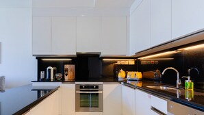 A modern kitchen with a built-in oven, a coffee machine, and a toaster. - Stylish 1BR unit Address Marina (Dubai)
