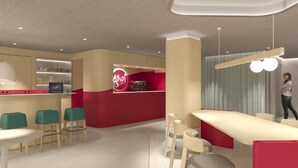A modern cafe with a red counter, green chairs, and a woman standing by the counter. - AHOI! Urban Beach Hotel (Palma de Mallorca)