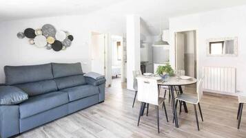 Deluxe Apartment, City View | Living area | TV