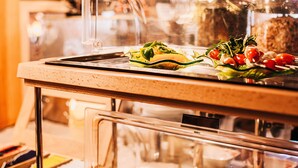 A buffet with various food items including a salad, meat, and other dishes.
