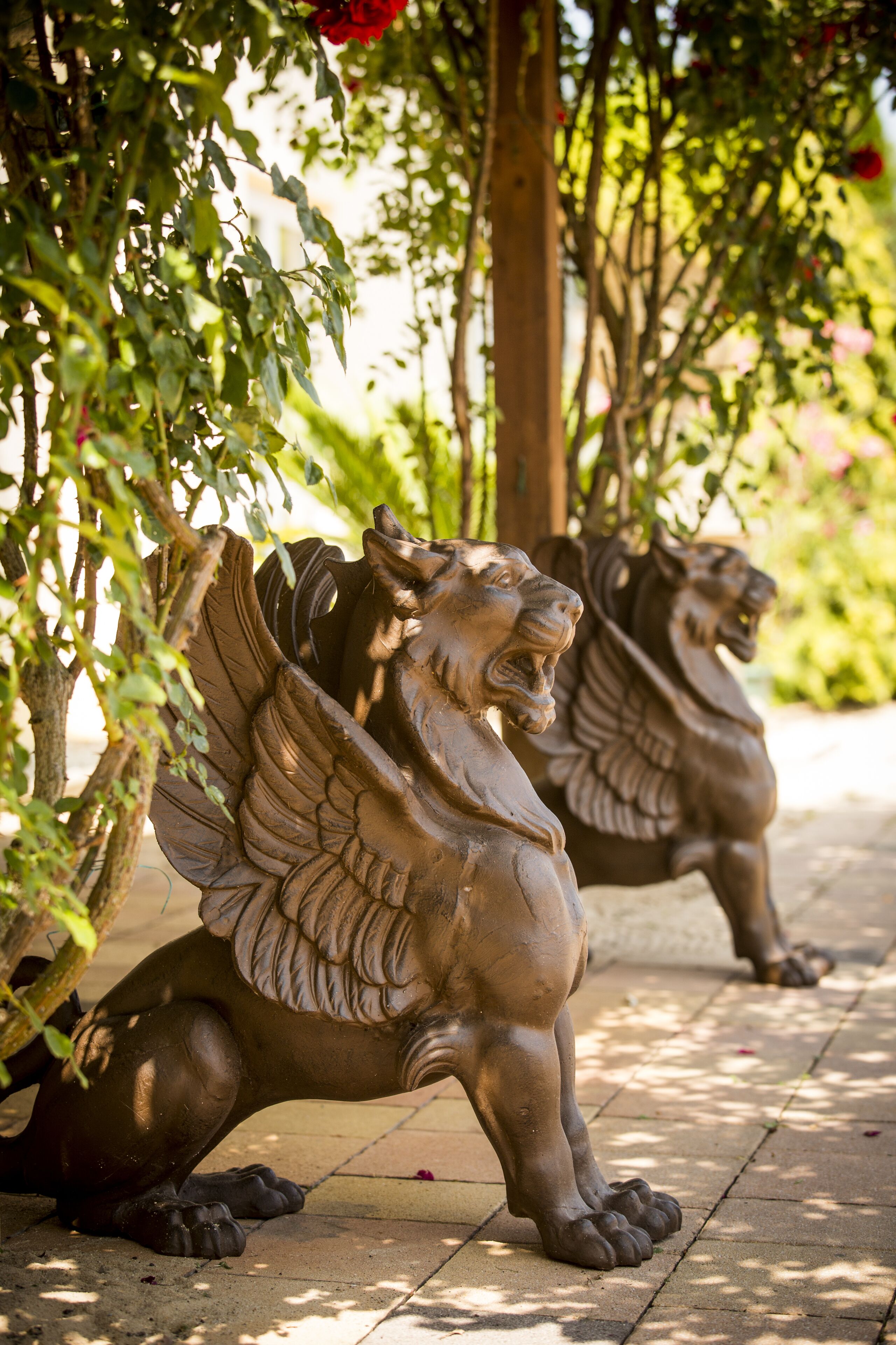 A garden with two bronze lion statues.