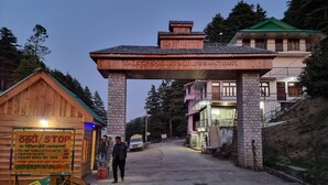 A wooden entrance gate with a sign reading "Kalatop K. Ajur Wildlife Sanctuary". - Smart Hill Kalatop (Dalhousie)