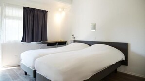 A hotel room with two single beds, a desk, and a chair. - Hôtel Aerel Aéroport Blagnac (Blagnac)