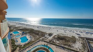 A resort with multiple swimming pools, a beach, and a clear view of the ocean. - Phoenix Gulf Towers 905 4 Bedroom Condo (Orange Beach)