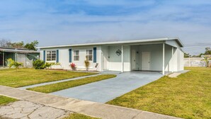A single-story house with a front porch, a driveway, and a well-maintained lawn. - 4 Mi to Beach: Charming Port Charlotte Home! (Port Charlotte)