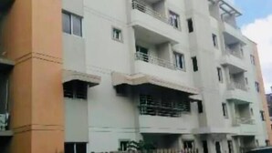 A multi-story residential building with balconies and a flat roof. - Burungos Place @ Terrazas Del Caribe D-202 (Santo Domingo Este)