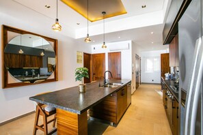 Sleek pendant lighting over your kitchen island adds ambiance and function - Amapas Oasis | Pool & Private BBQ (Puerto Vallarta)