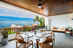Dine al fresco with sweeping views of the bay, city, and lush hills. This spacious balcony is perfect for sunset dinners or morning coffee. - Amapas Oasis | Pool & Private BBQ (Puerto Vallarta)