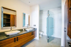 Primary ensuite bathroom with spacious double vanity, modern fixtures, and glass walk-in shower - Amapas Oasis | Pool & Private BBQ (Puerto Vallarta)