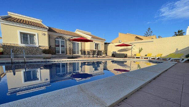 A pool area with lounge chairs, a table, and umbrellas. - Casa Sabine, beautiful, modern, rural villa with 10m x 5m private pool (Zurgena)