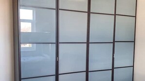 A room with a large, dark-colored wardrobe with multiple compartments. - Fantasy accommodation in Golders Green/ Brent Cross  (London)