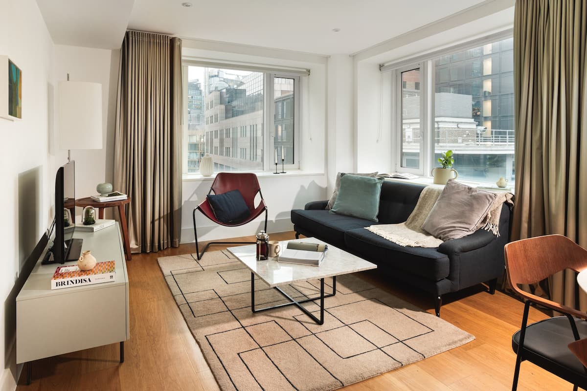 A modern living room with a sofa, coffee table, and chairs.