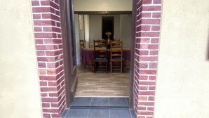 Una puerta que da a un comedor con una mesa y sillas.