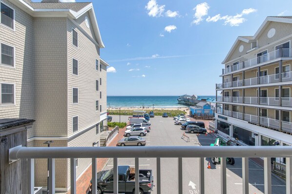 A multi-story hotel with a view of the beach, parking lot, and a pier. - Condo Room 300 Grand Victorian's Largest Rental! (Old Orchard Beach)