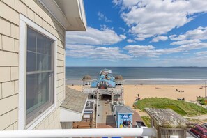 A pier with a sign reading "The Pier" overlooking a beach. - Beautiful Direct Ocean Front 2 bedroom w/ private balcony (Old Orchard Beach)