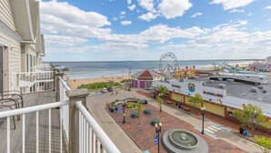 A beachfront hotel with a Ferris wheel, a boardwalk, and a beach in the background. - Grand Victorian unit 511 (Old Orchard Beach)