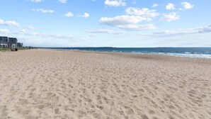 A wide sandy beach with a clear sky and distant horizon. - Grand Victorian unit 511 (Old Orchard Beach)