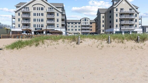 A beachfront hotel with multiple balconies and a sandy beach in front. - Grand Victorian unit 511 (Old Orchard Beach)
