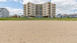 A multi-story hotel with a flat roof, located near a sandy beach. - Oceanfront Seawatch Condo unit 402 (Old Orchard Beach)