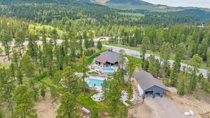 A resort with a swimming pool, a covered outdoor area, and a view of the surrounding forest and hills. - Moonlit Summit with hot tub, lots of great parking and views (Lead)