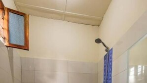 A bathroom with a toilet, sink, and shower. - Family room with balcon - Explore semplicity immerse yourself in nature  (Michamvi Kae)