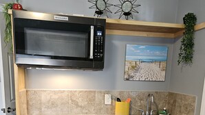 A compact kitchen with a built-in microwave, a sink, and a small countertop. - Tranquility: near Carlisle, Harrisburg, Messiah, Lancaster, Hershey attractions (Dillsburg)