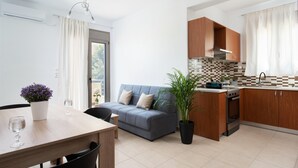 A modern kitchen with wooden cabinets, a built-in oven, and a tiled backsplash. - Tulipa Suites (Monemvasia)