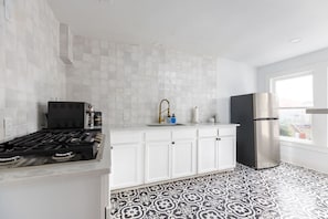 Fridge, coffee/tea maker, cookware/dishes/utensils