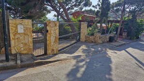 A gated entrance with stone walls and a metal gate. - Amazing View Costa Brava (Lloret de Mar)
