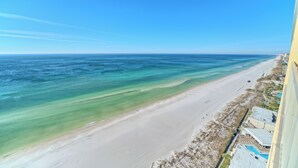 A beach view from a high-rise building with a clear sky. - Gulf Crest 2304 | Your Gulf-Front Home Away From Home! (Panama City Beach)