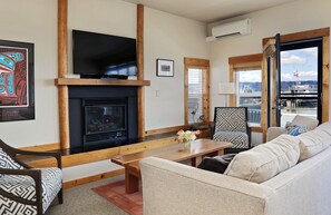 TV, fireplace, books - Waterfront 1 bedroom condo - private deck offering spectacular views (Langley)