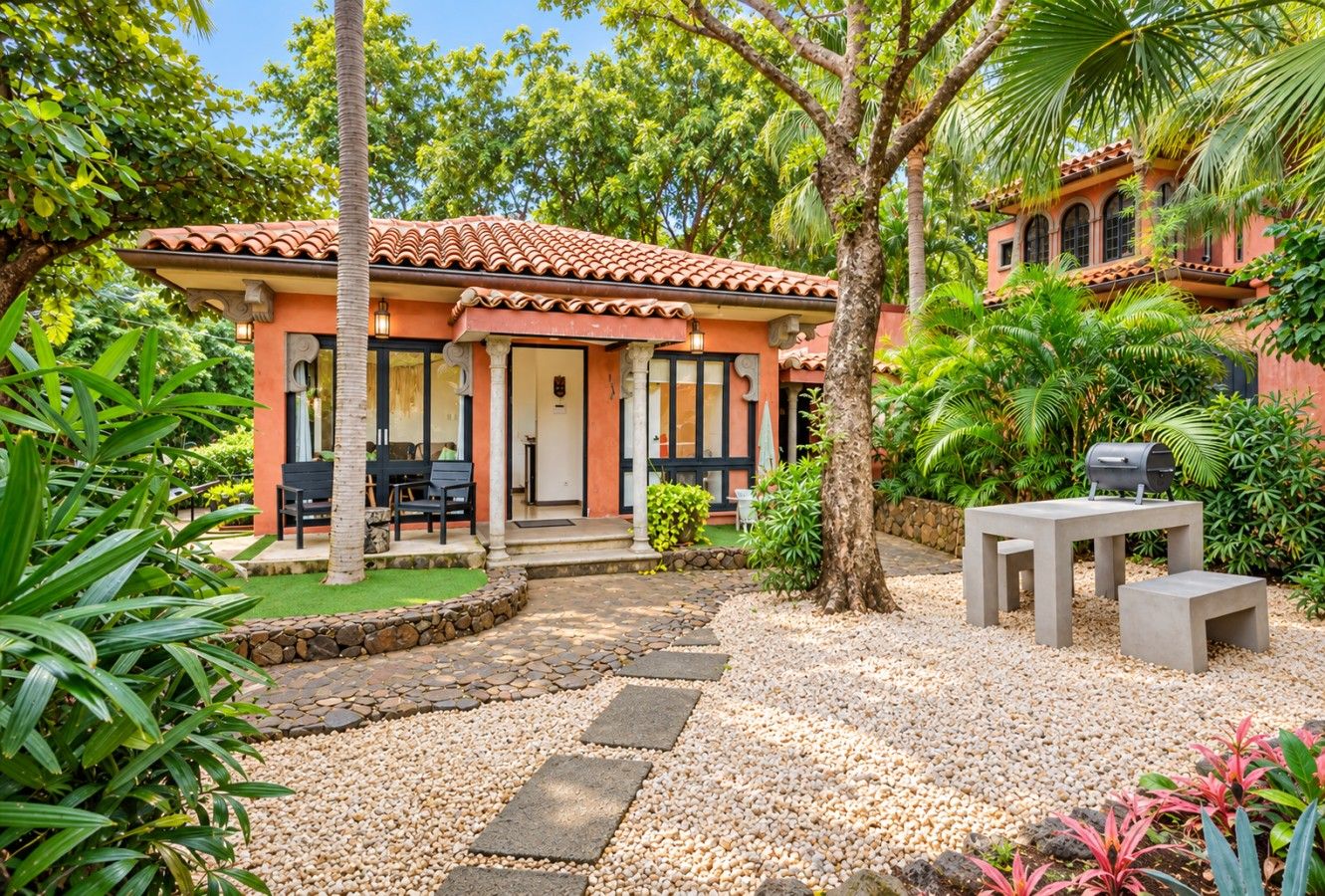 Shared tropical courtyard. The private studio is behind the front casita.
