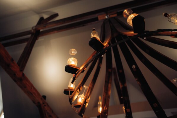 A ceiling with a wooden structure supporting multiple light fixtures.