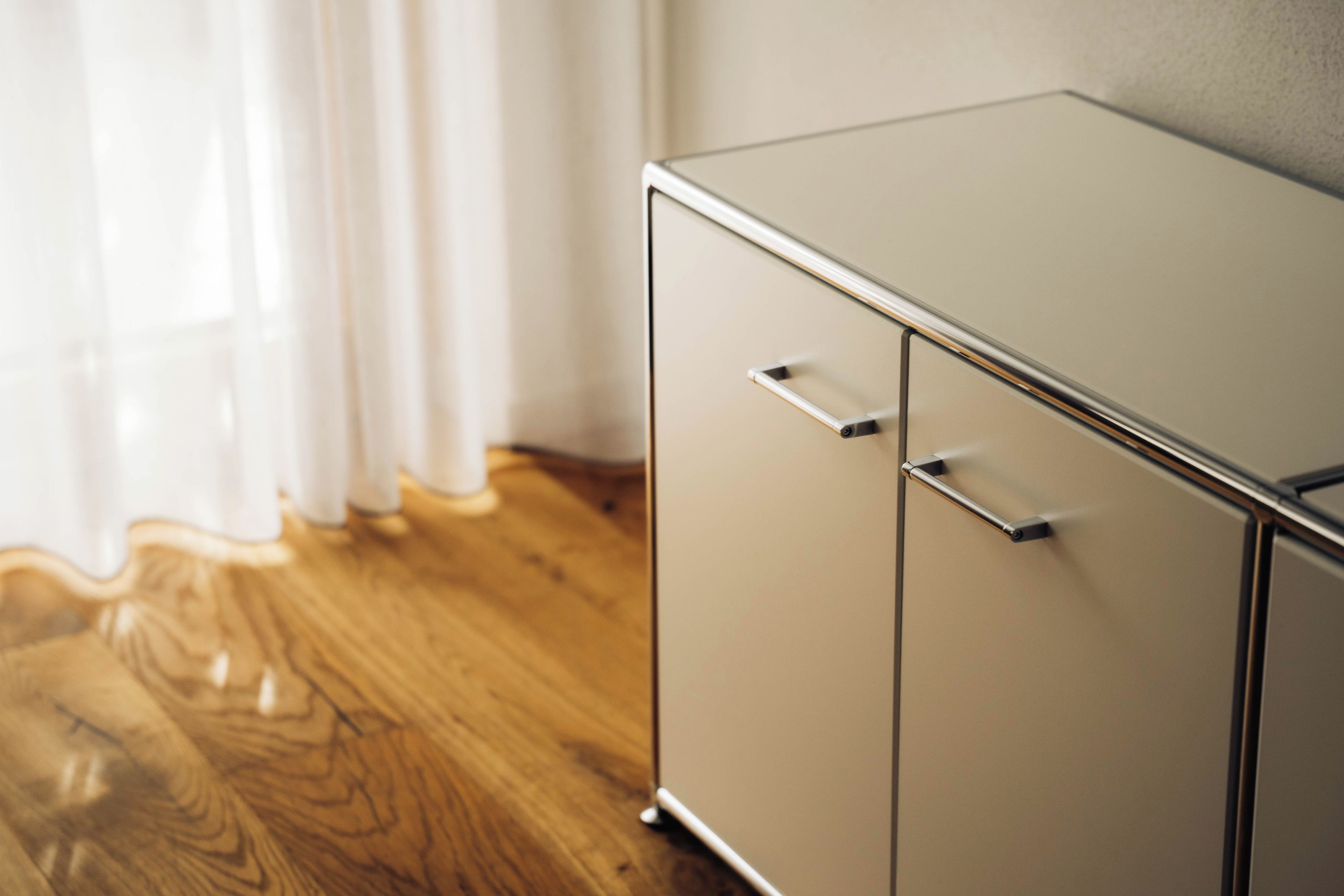 A wooden floor and a metallic cabinet with two drawers.